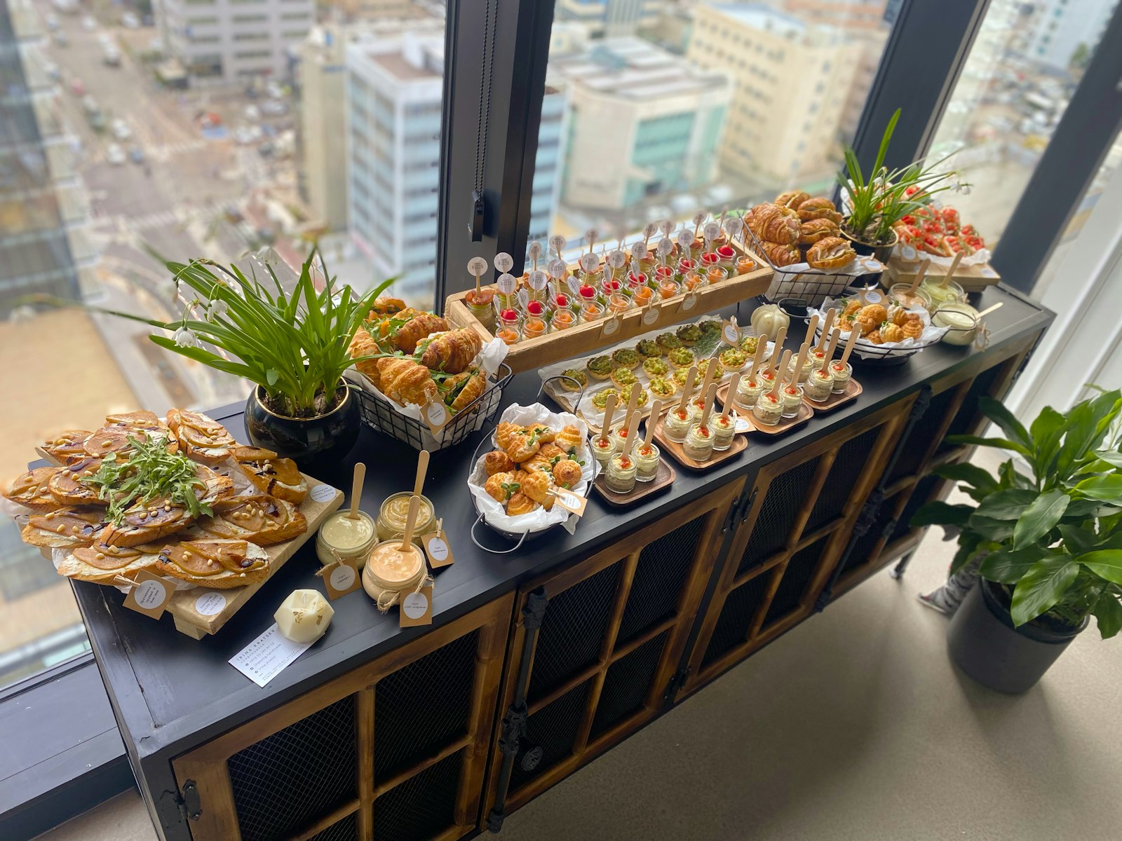 A catering spread laid out along a sideboard in a city office